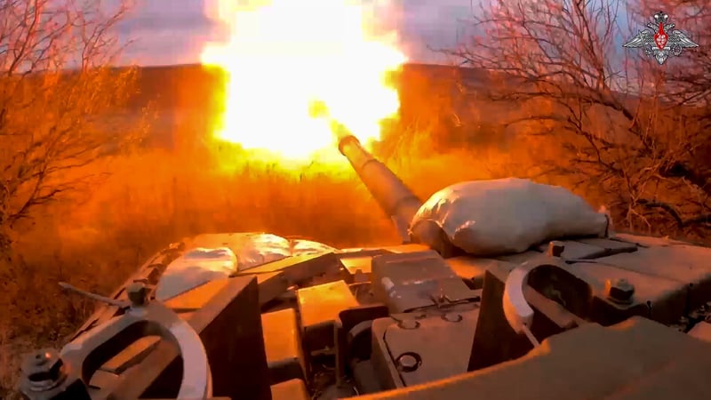 A Russian tank fires at Ukraine.