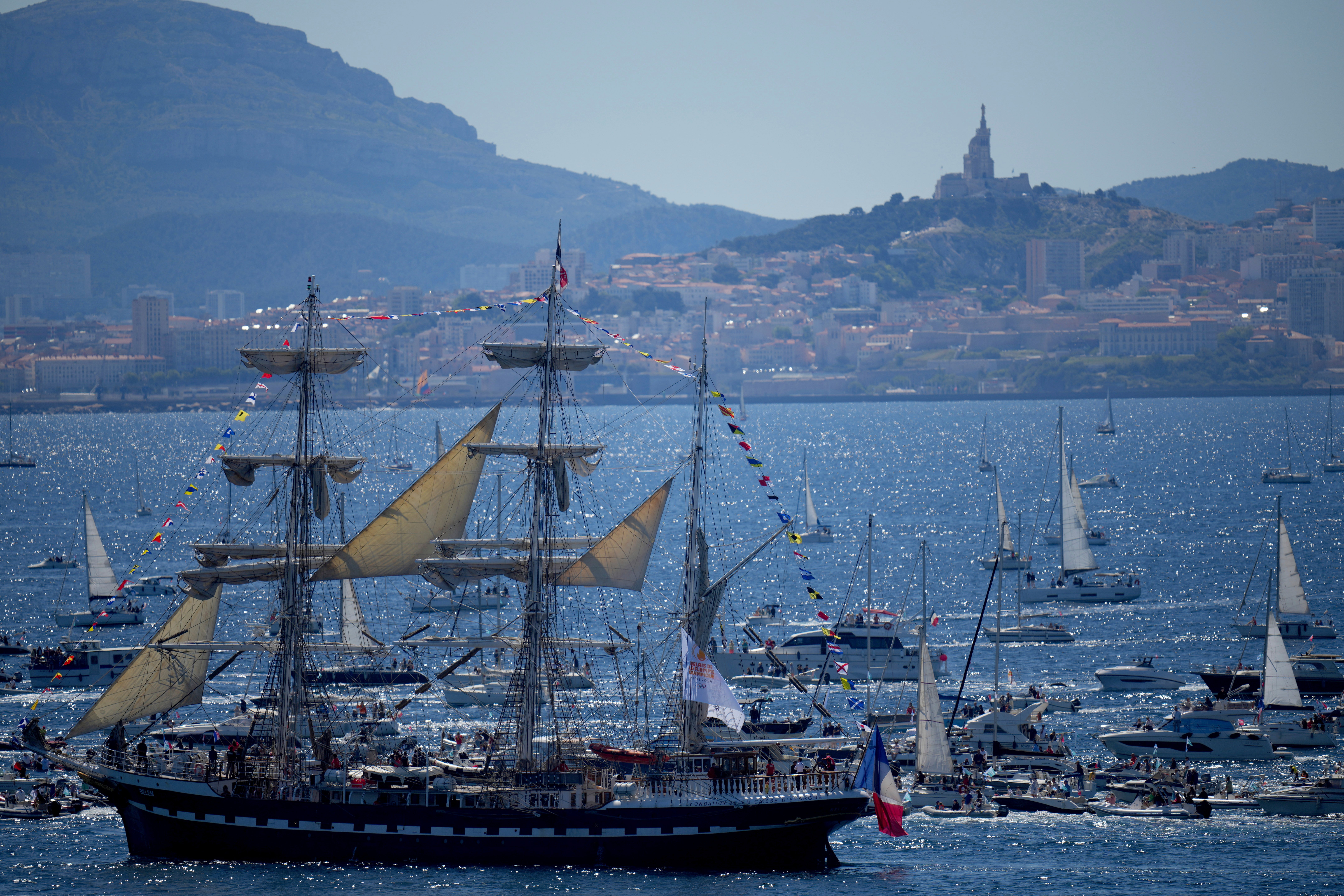A three-masted ship bearing the Olympic torch arrives in Marseille.
