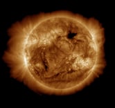 An ultraviolet image of the sun and its atmosphere in space.