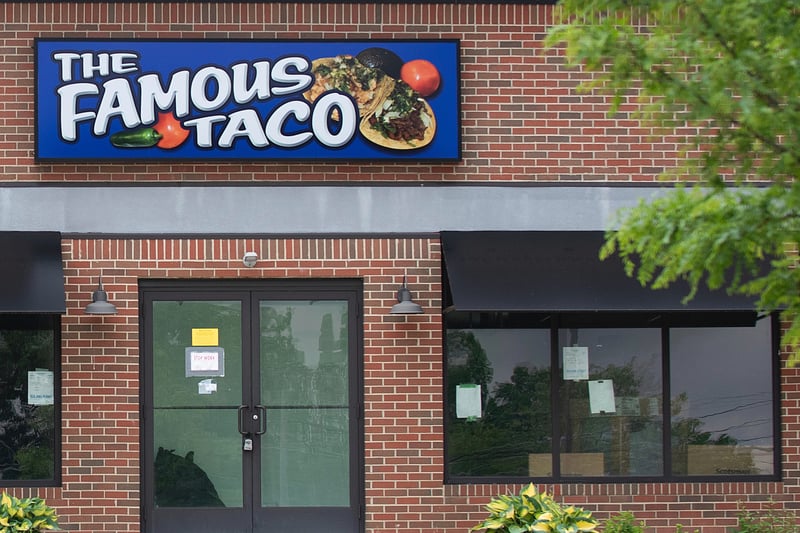 A sign for The Famous Taco above the entry to a storefront.