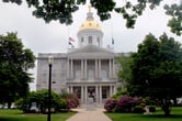 A statue of Daniel Webster in front of the New Hampshire State House.
