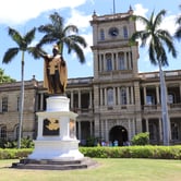 The Hawaii State Supreme Court courtyard features an 18-foot-tall bronze statue of King Kamehameha I, the legendary unifier of the Hawaiian Islands, gilded in gold.