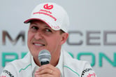Michael Schumacher speaks into a microphone.