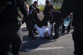 Israeli police officers move an ultra-Orthodox Jewish man during a protest.