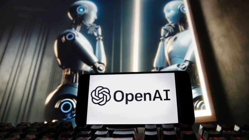 The Open AI logo on a phone in front of an image of a robotic figure gazing at its reflection.