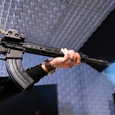 Photo of AR-15 held by pair of hands