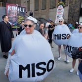 Women dressed as abortion pills gather in front of people dressed as Supreme Court justices.