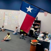 A Texas flag hanging in a classroom.