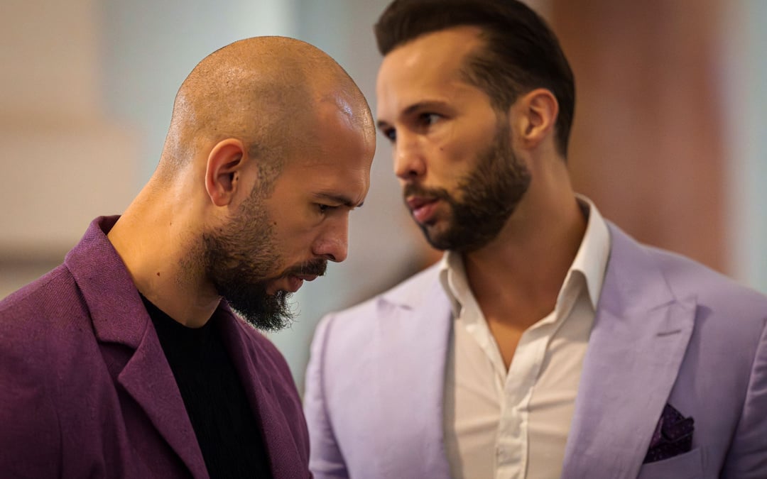 Influencer Tate brothers, who face human trafficking charges in Romania, arrive in the US