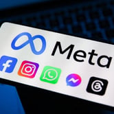A phone screen showing the Meta infinity logo with Facebook, Instagram, WhatsApp, Messenger and Threads icons.