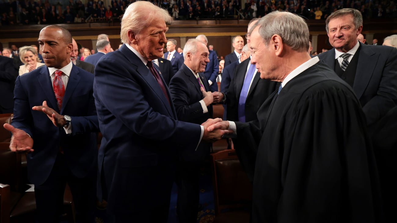 President Donald Trump, center, greets Chief Justice of the Supreme Court John Roberts, right, as he arrives to address a joint session of Congress at the Capitol in Washington, Tuesday, March 4, 2025. (Win McNamee/Pool Photo via AP)
