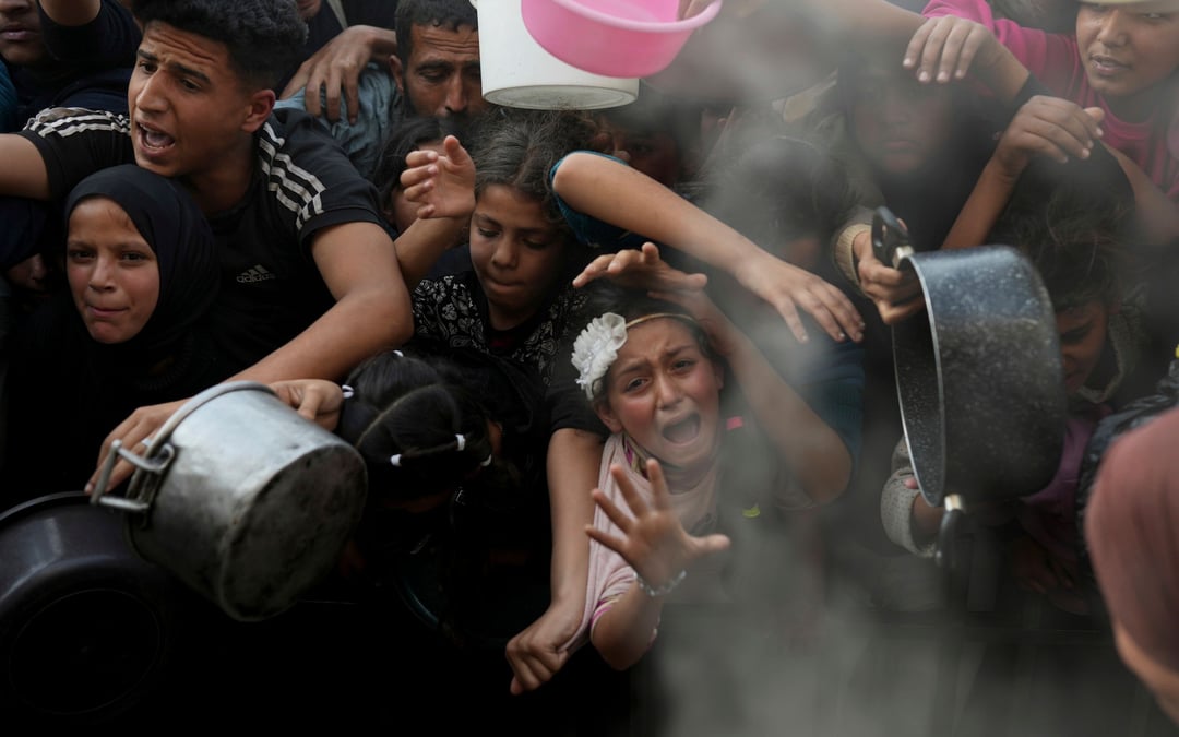 Desperate children and adults in Gaza struggle to get food as Israel blocks aid