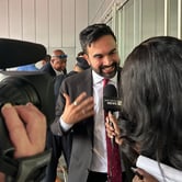 A man being interviewed by a woman