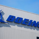 The Boeing logo along the side of a gray building.