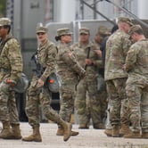 U.S. military personnel gather and walk.