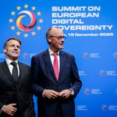 Emmanuel Macron and Friedrich Merz in front of a blue backdrop with white words reading "Summit on European Digital Sovereignty, 18 November 2025."