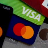 Credit cards with Visa and Mastercard logos overlapping.