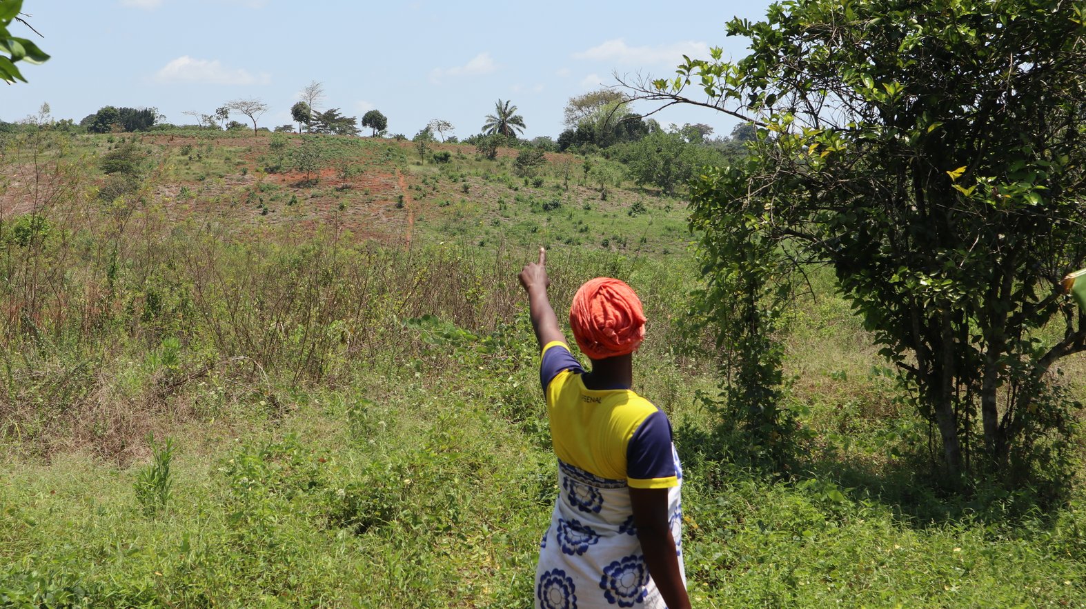 Bomba Sita woman points to EACOP route on their land. Photo by Dawn Attride.