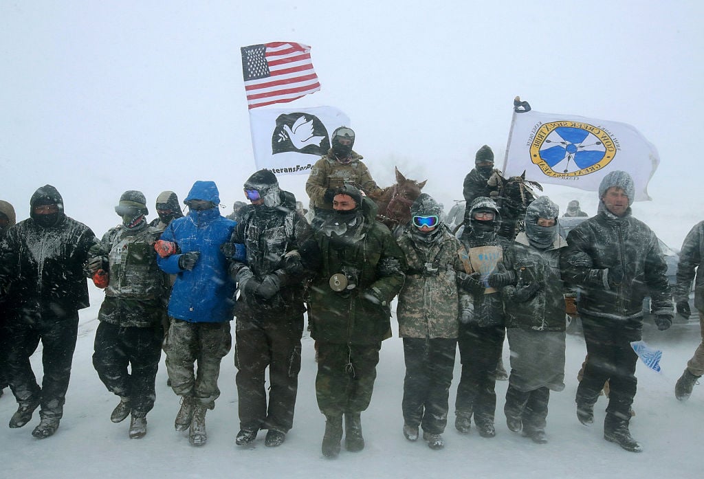 CANNON BALL, ND - DECEMBER 05: Despite blizzard conditions, military veterans march in support of the water protectors at Oceti Sakowin Camp on the edge of the Standing Rock Sioux Reservation on December 5, 2016 outside Cannon Ball, North Dakota. Photo by Scott Olson/Getty Images
