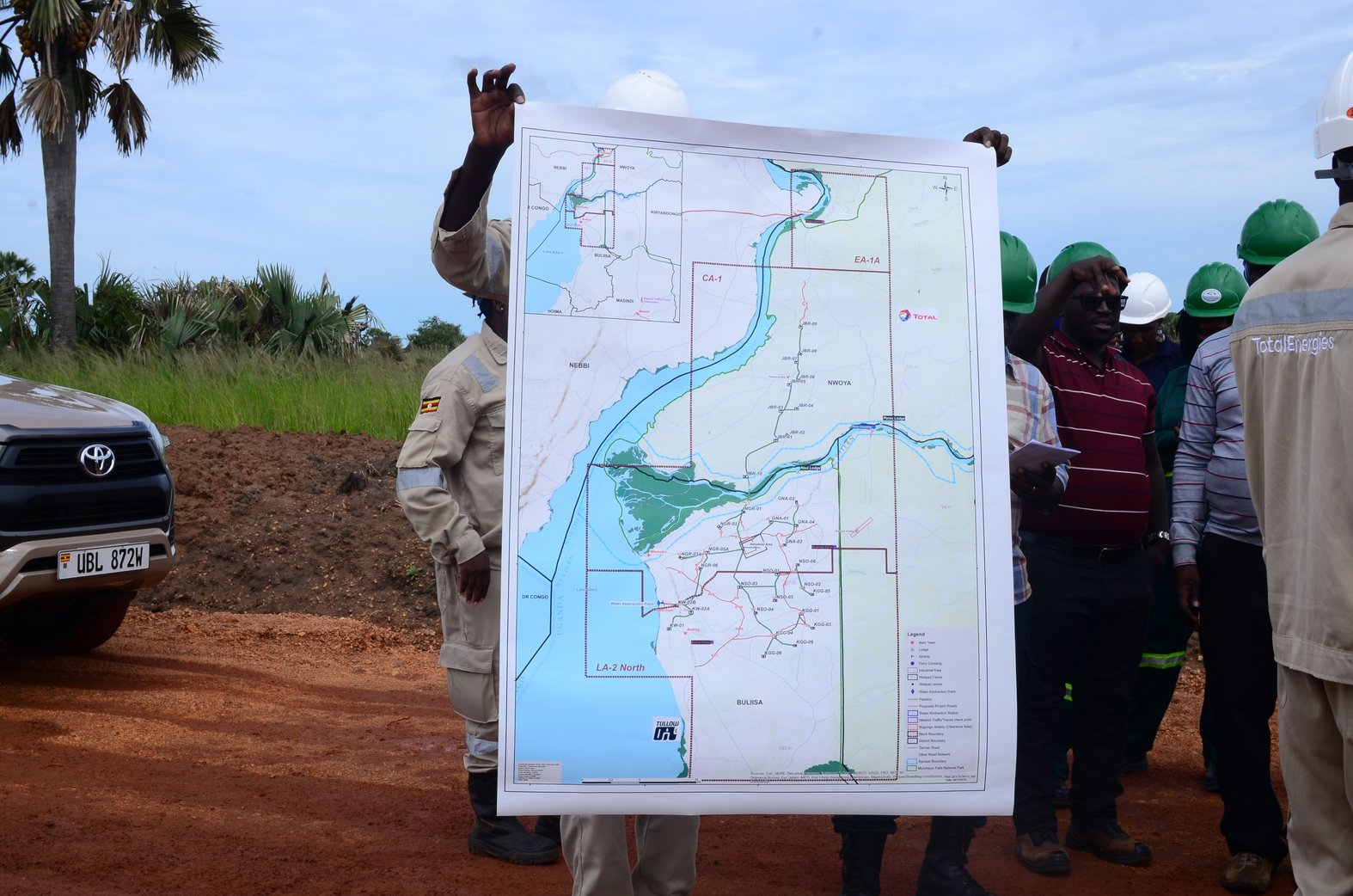A TotalEnergies official displays the Tilenga project map  highlighting its location inside the national park