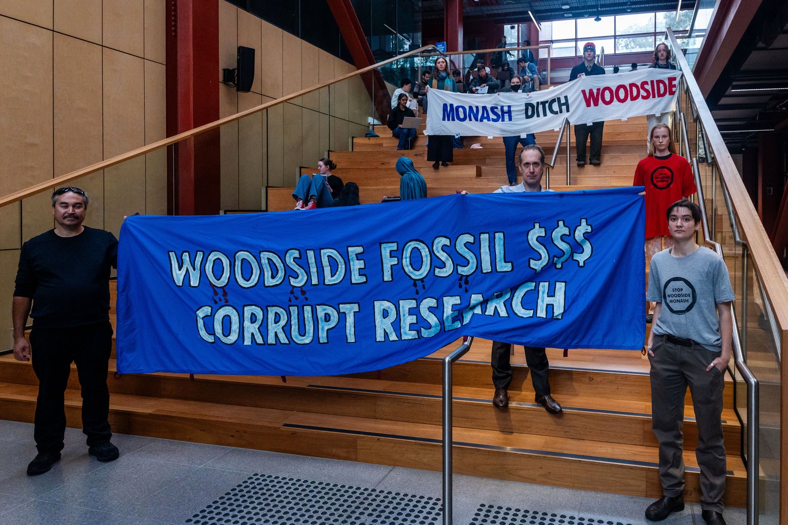 Student and faculty members of Stop Woodside Monash protest in the Woodside building. Photo by Sean Davey.
