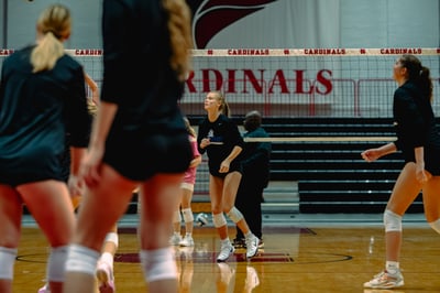 A player in black moves forward on a court.