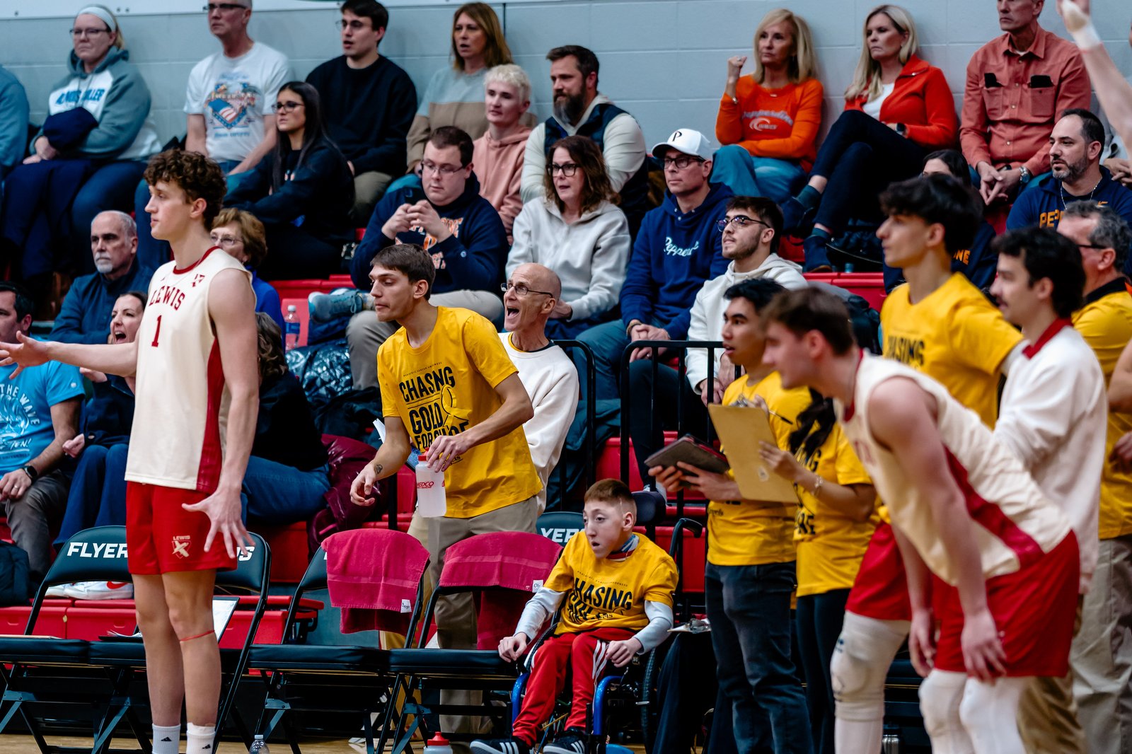 A Lewis player in a white and red uniform gestures on the court during a game.