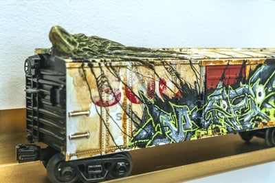 A model train car with graffiti art.