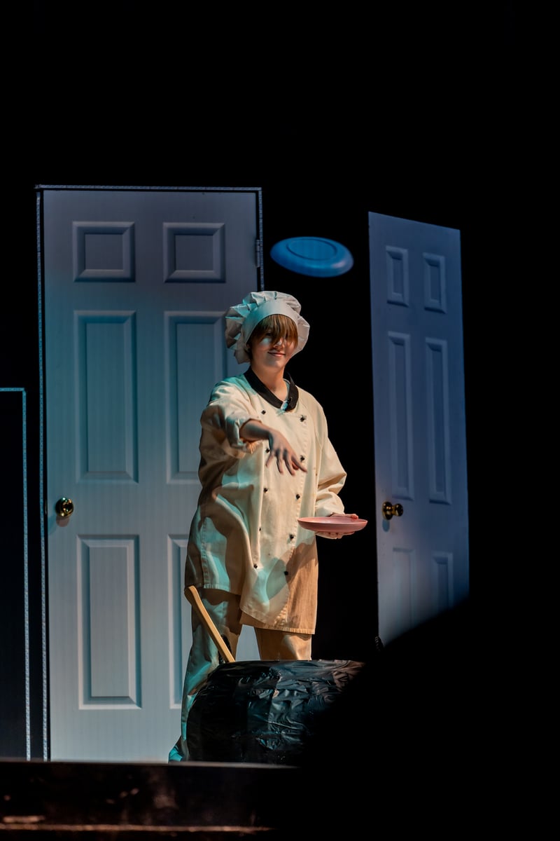 A performer on stage in a school theater production