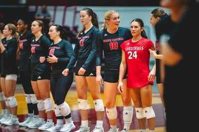 A player in red talks to a North Central player in black.