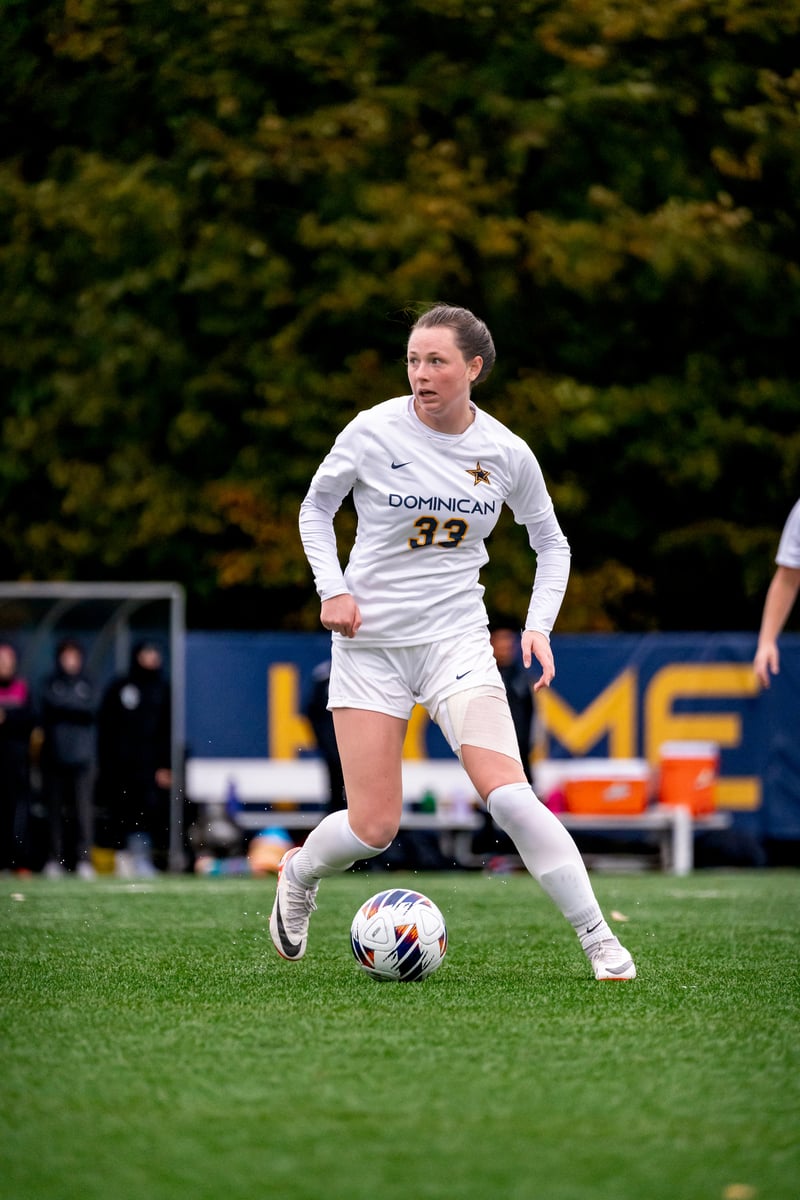 A soccer player moving with the ball on the field