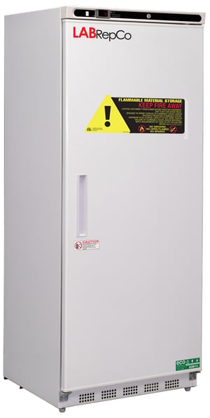 A freestanding 20 cubic foot laboratory freezer for flammable material storage with a warning sticker and recessed handle