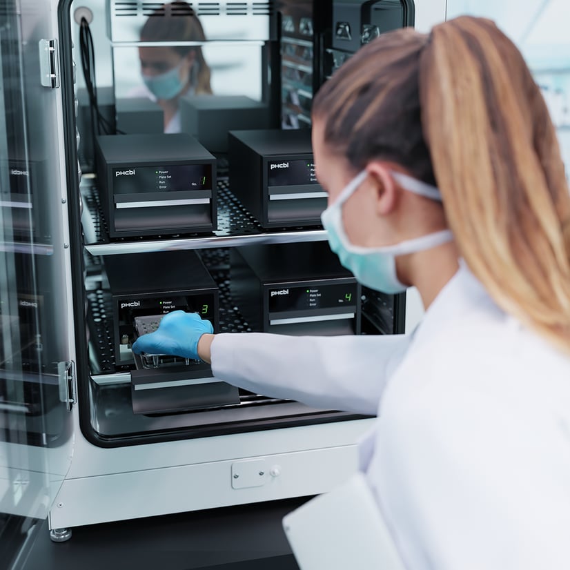 woman scientist working inside a CO2 incubator with the PHCbi LiCellMo product
