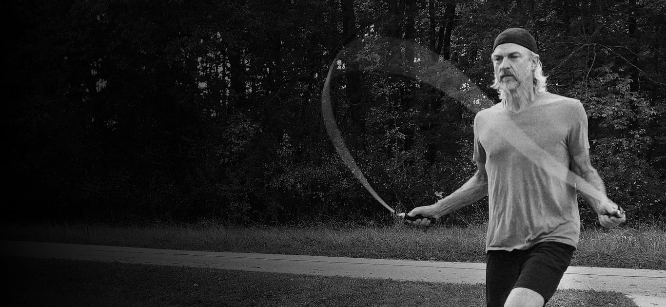 Todd jump roping outdoors on a jump rope mat.