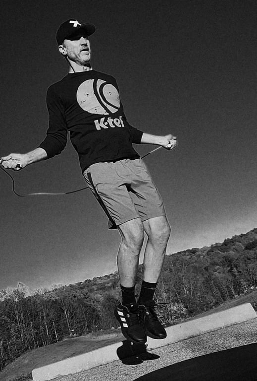 Todd Jones jumping rope outdoors.