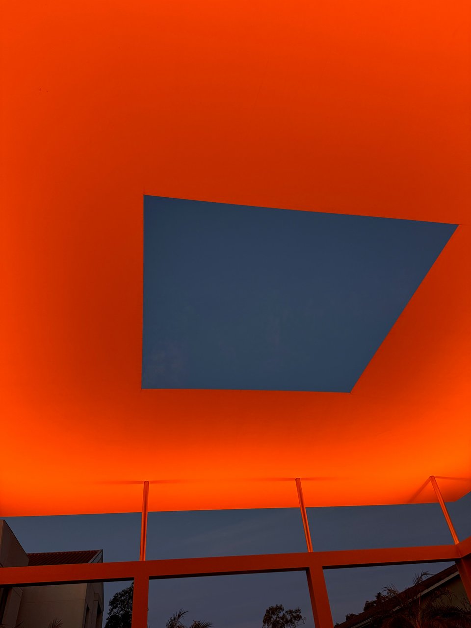 Photo of James Turrell's Skyspace exhibition. The sky is visible in a rectangular viewport with orange-ish light around the viewport.