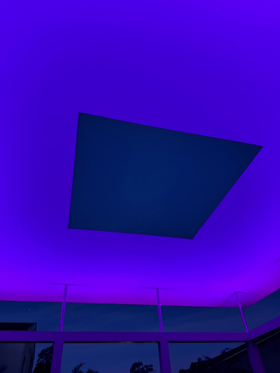 Photo of James Turrell's Skyspace exhibition. The sky is visible in a rectangular viewport with purple-ish light around the viewport.