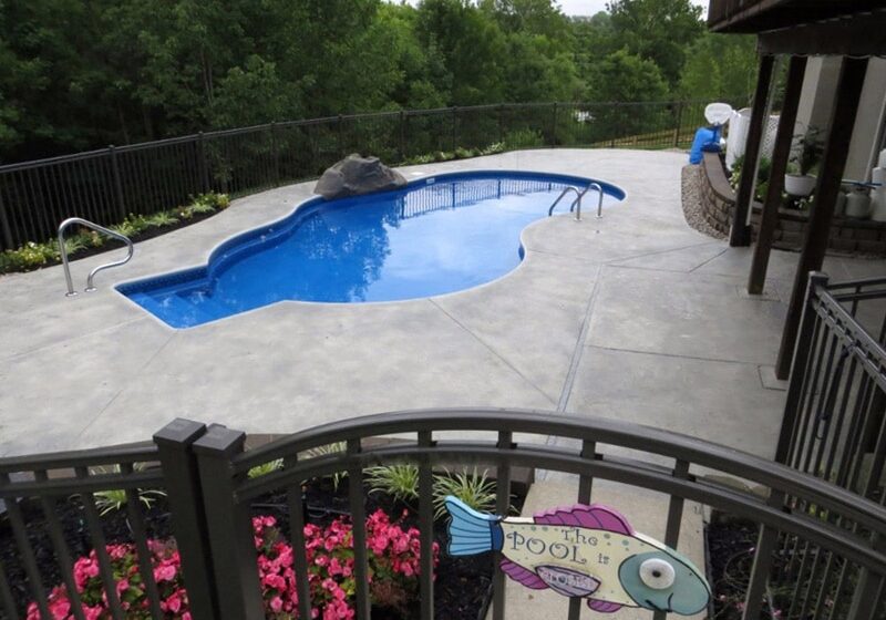 Luxury pool deck with water features installed by Newport News Concrete in Virginia Beach