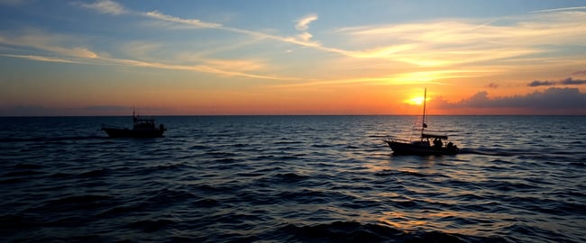 Sunset Serenity: Ocean View with Fishing Boats