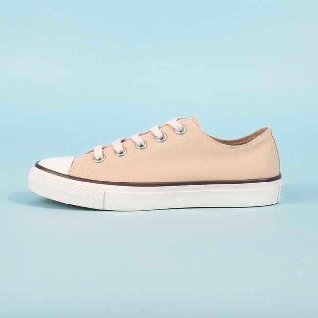 Beige Sneakers on Blue Background