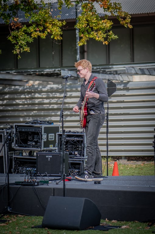 Ashton Jude performing live concert with crowd in background