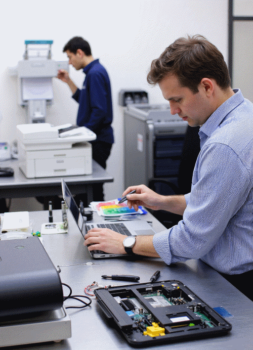 Technician repairing laptop and printer devices in Thane repair shop