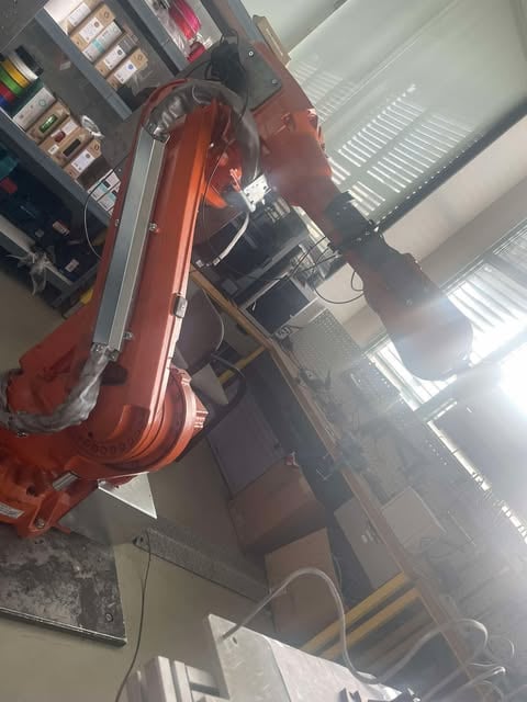 Alex Chen working on a robotics project in a laboratory setting