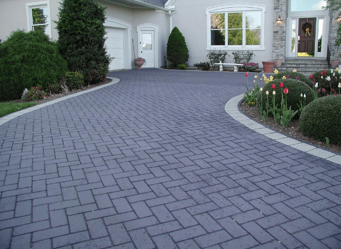 Close-up of various stamped concrete pattern samples showing texture and design options