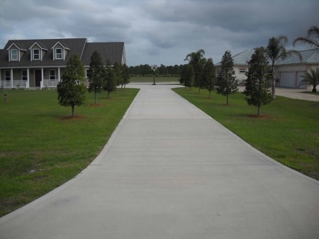 Person sealing a concrete driveway in Virginia Beach to protect against winter weather damage