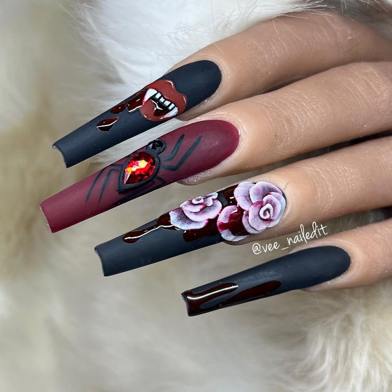 In this image show, the black and red color long kiss shape nails design for valentines day.