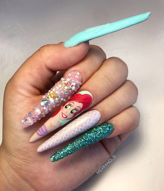 In this image show, the long cute blue peach with the disney-inspired mermaid nails design.