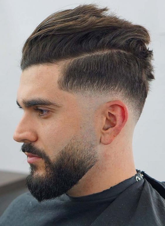 the image shows, drop fade haircut with beard