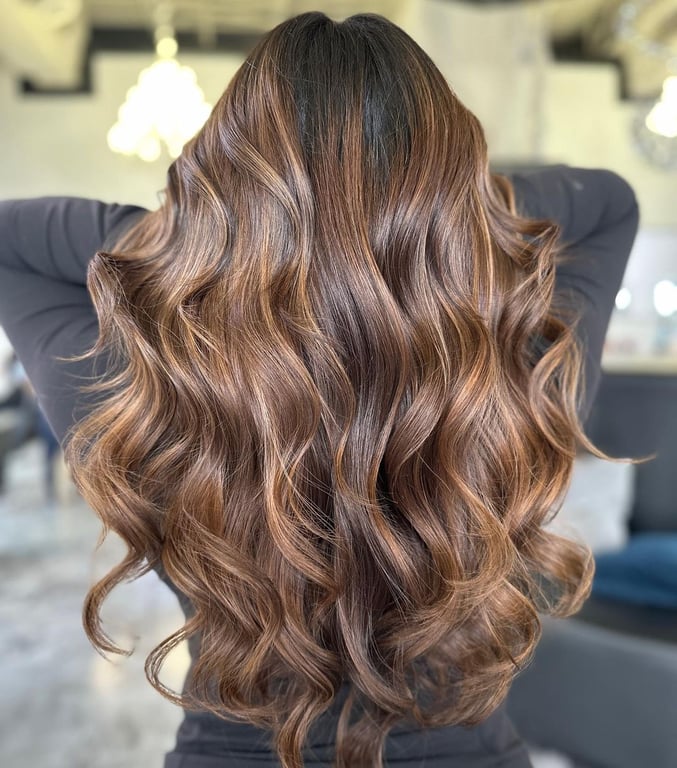 In this image show, the Caramel Balayage With Curled Ends hairstyles.