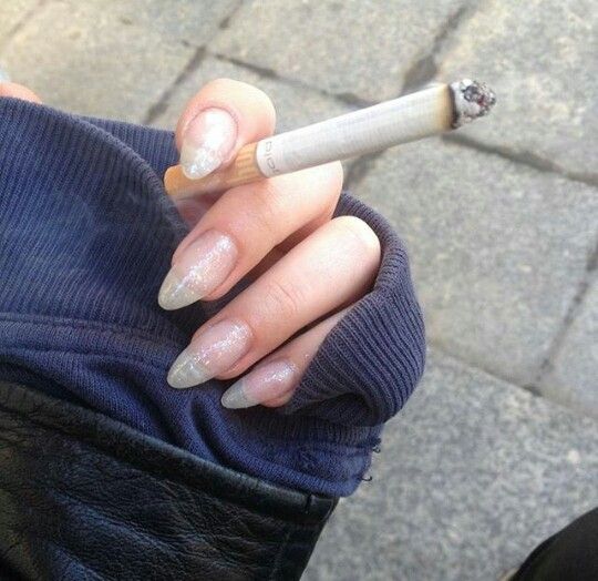 the image shows, hand holding a cigarette